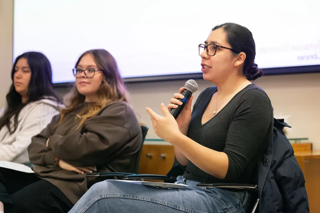 Three people speaking during a panel discussion.